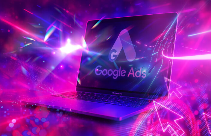 Frese & Wolff Werbeagentur, grafisches Element, das einen aufgeklappten Laptop mit dem Schriftzug Google Ads zeigt, alles in Magentatönen gehalten